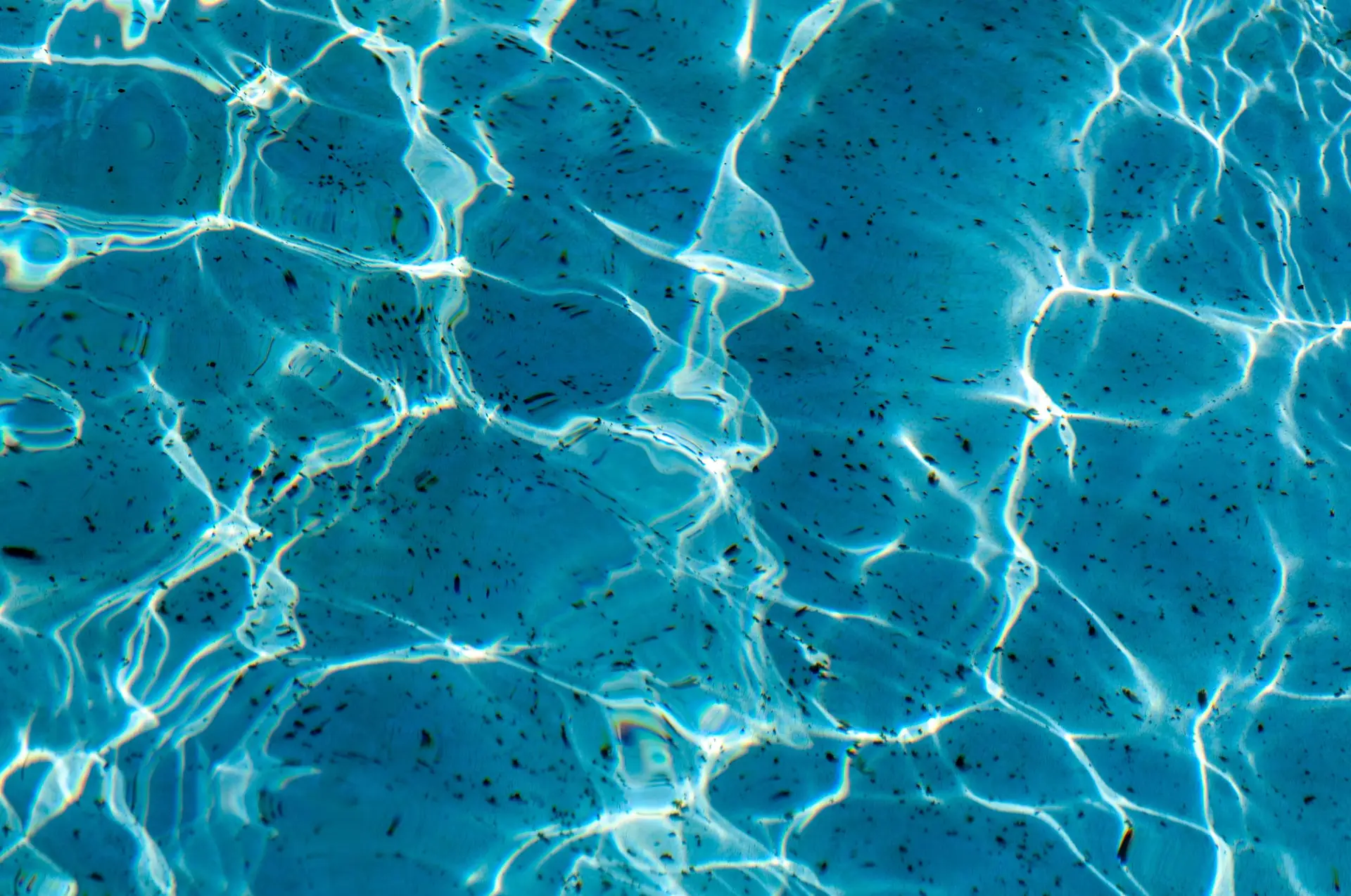 Sunlight reflected across ripples on blue water